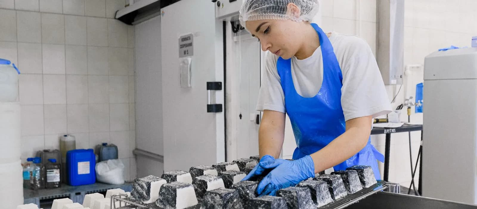 Food production worker in apron and hairnet